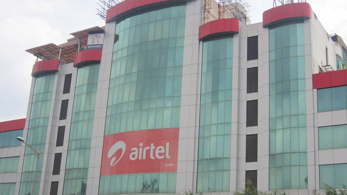 Glass-fronted office building with a large red Airtel logo banner
