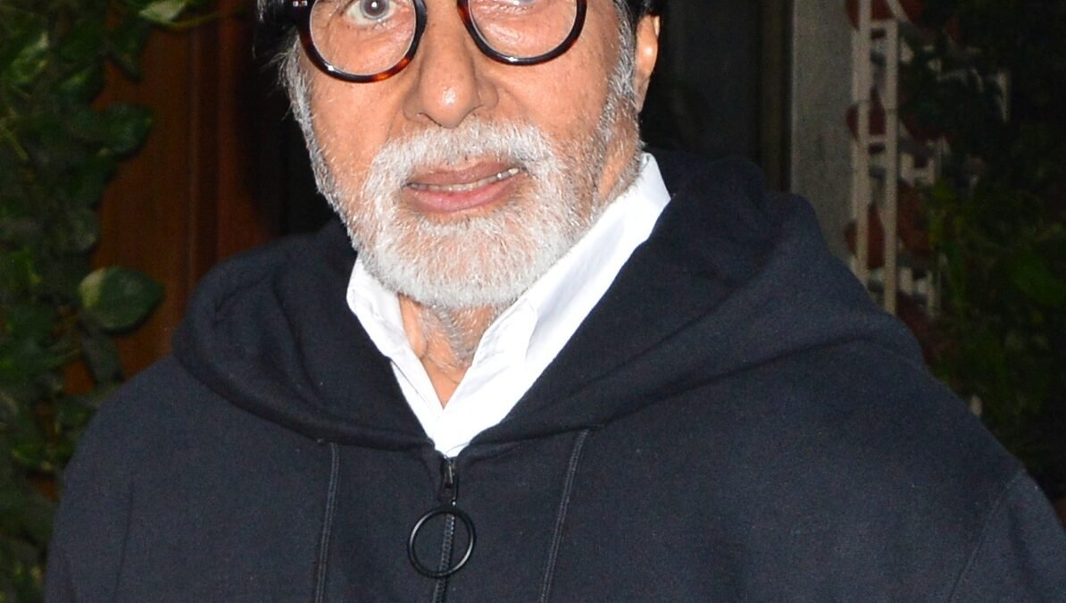 Actor Amitabh Bachchan in glasses and a dark jacket