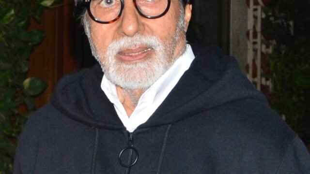Actor Amitabh Bachchan in glasses and a dark jacket