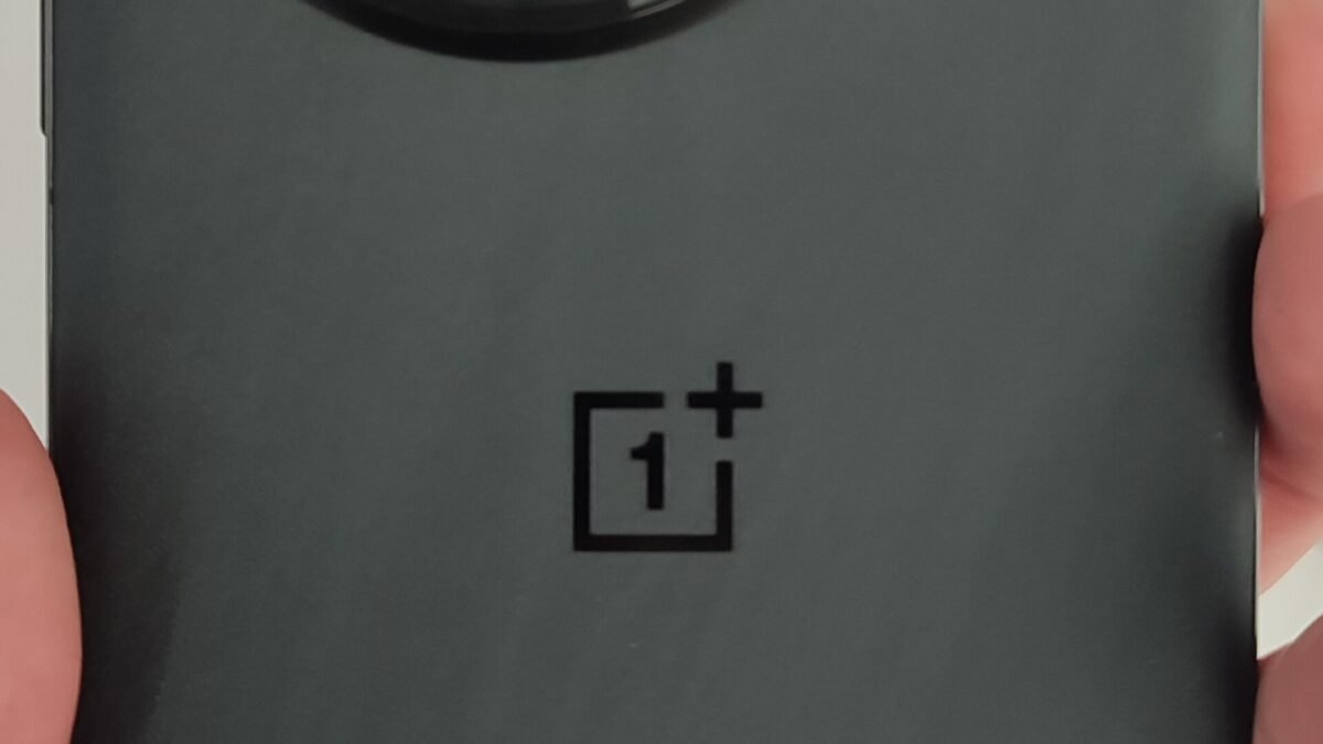Back of a black OnePlus 13 smartphone showing its circular camera module