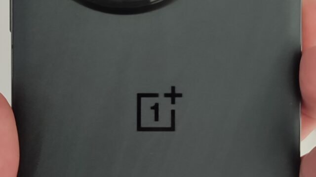 Back of a black OnePlus 13 smartphone showing its circular camera module