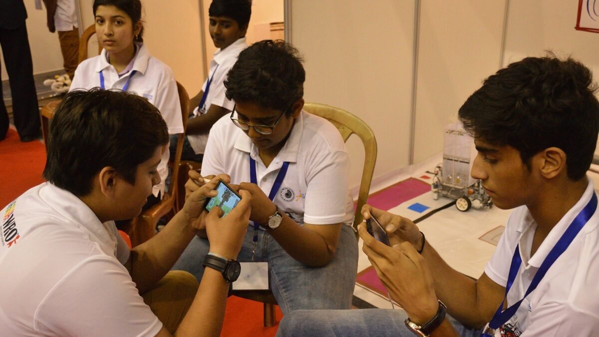 Students playing a mobile game on smartphones