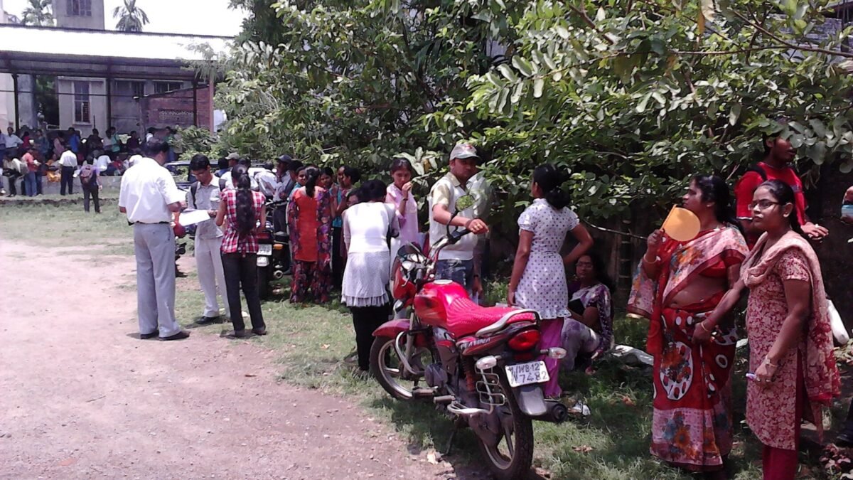 Students and parents waiting outside an examination hall in India