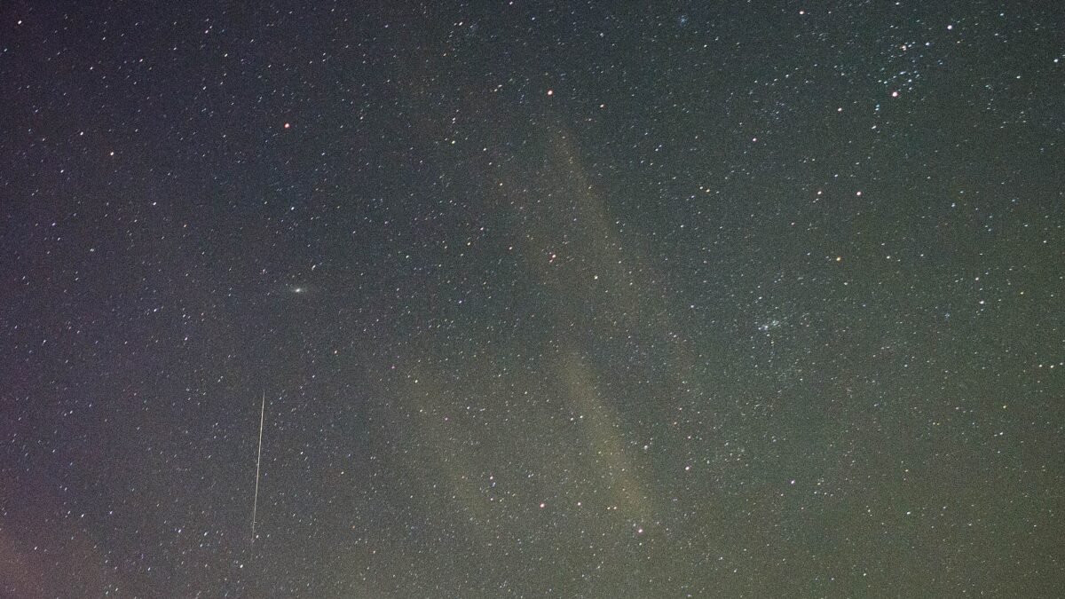 A meteor streaking across a starry night sky