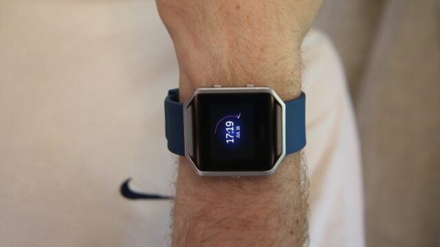 A Fitbit activity tracker worn on a wrist