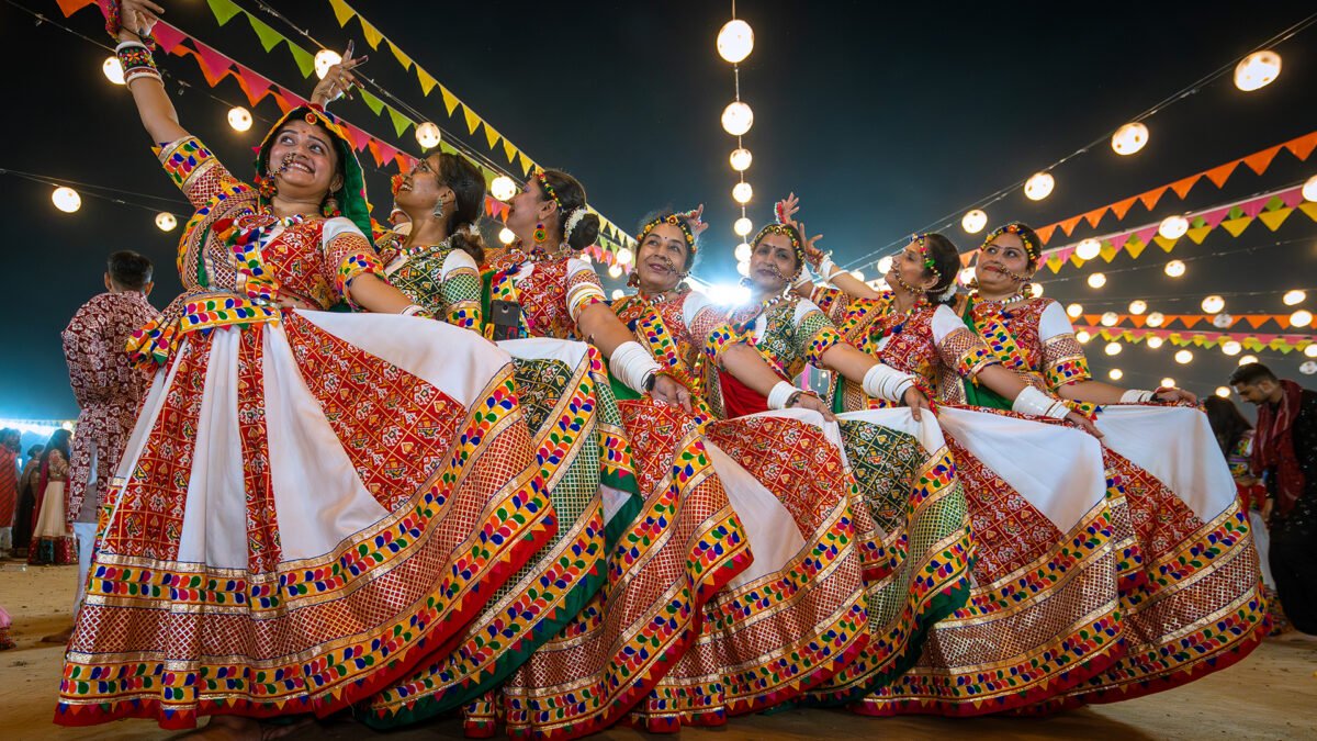 Dancers in traditional dress performing garba during Navratri