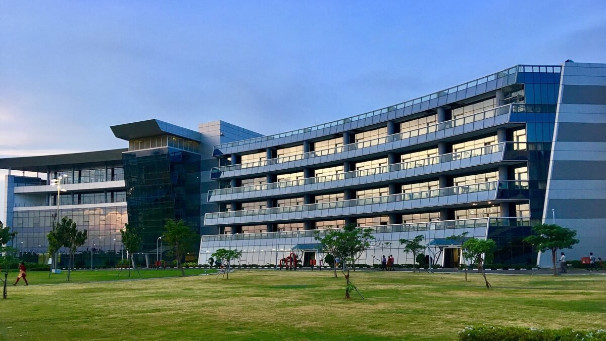 A TCS office building with glass facade and lawn