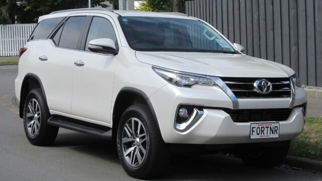 A white Toyota Fortuner SUV (standard model, not the Leader Edition)